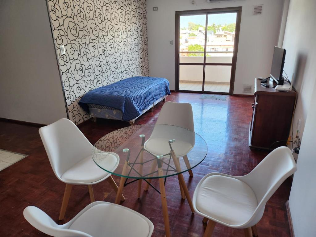 a room with three chairs and a table and a bed at Departamento Centro in San Fernando del Valle de Catamarca