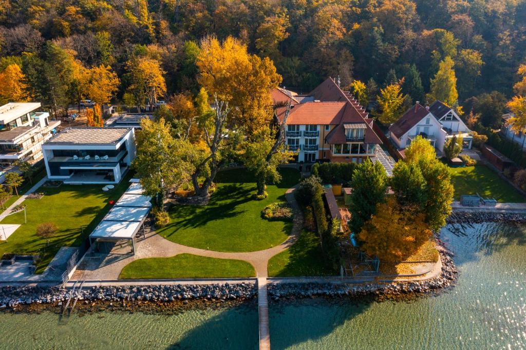 an aerial view of a house on the water at Tópart Hotel in Balatonvilágos