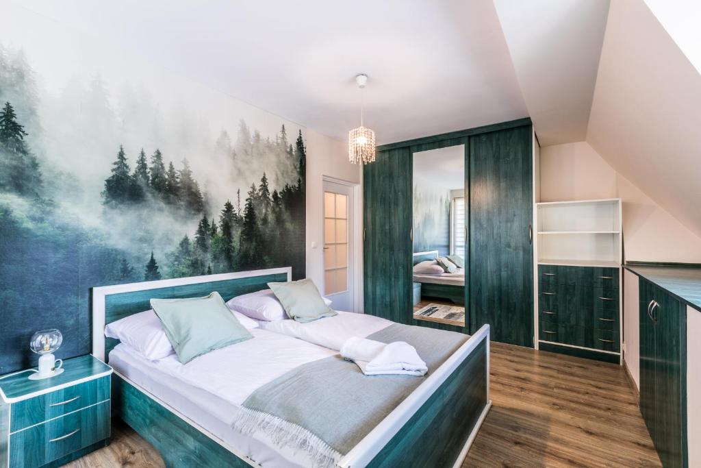 a bedroom with a bed with a painting on the wall at Apartament Bystry Potok in Zakopane