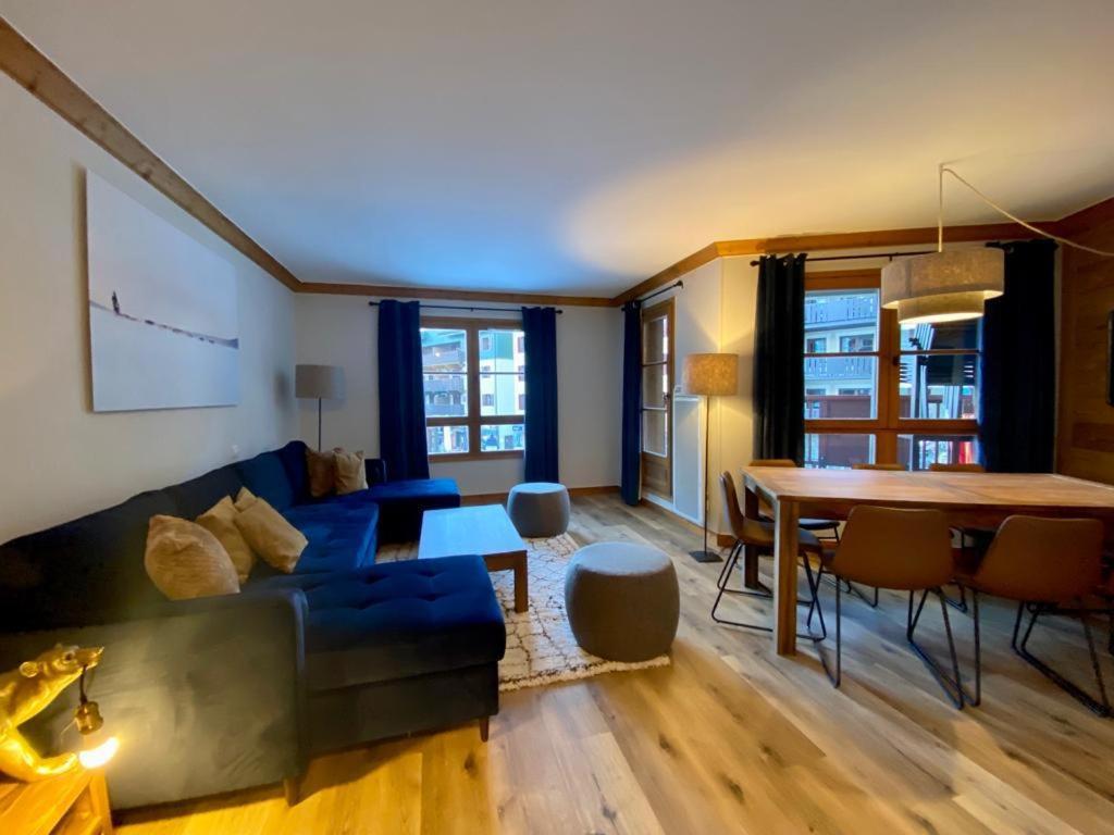 a living room with a couch and a table at Big Tartiflat, Arc 1950, 2 bed ski-in ski-out in Bourg-Saint-Maurice