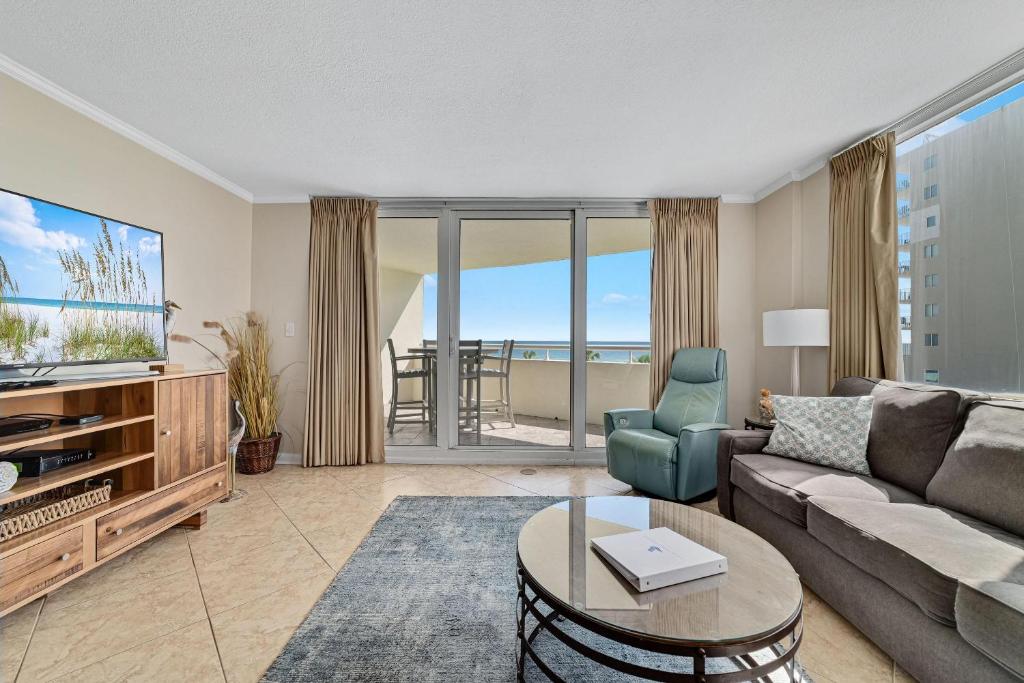 a living room with a couch and a tv at Perdido Sun 214 in Perdido Key