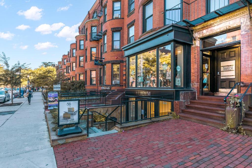 a brick building on a city street with a storefront at 304 Newbury Street by Thatch in Boston