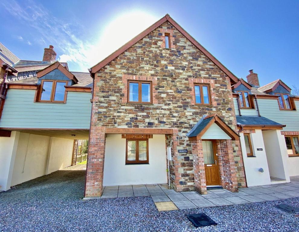 a large brick house with a garage at Genesta in Saint Minver