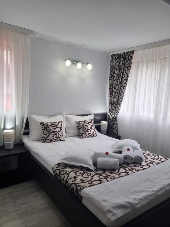 a bedroom with a large bed with a teddy bear on it at Casa Thor in Sinaia