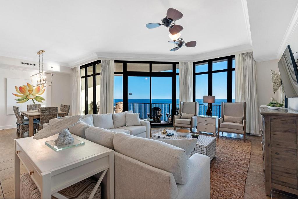 a living room with a couch and a table at Phoenix West 2005 in Orange Beach