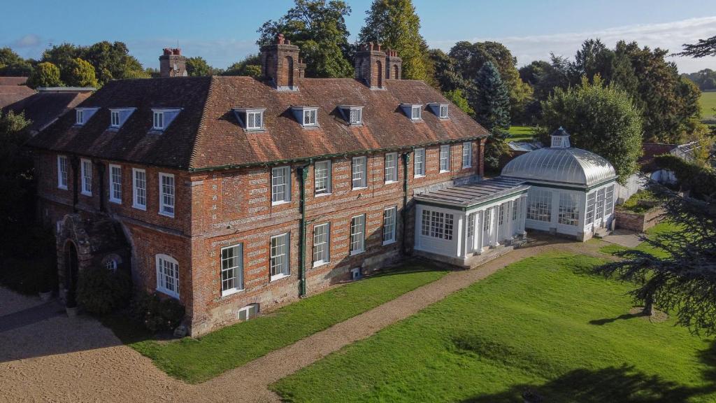 an aerial view of a large house with a greenhouse at The Manor House at Norton Park in Winchester