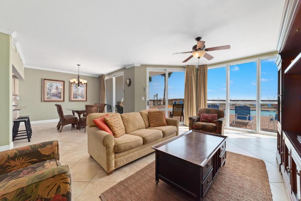 a living room with a couch and a table at SeaSpray West 105- Gulf Front in Perdido Key