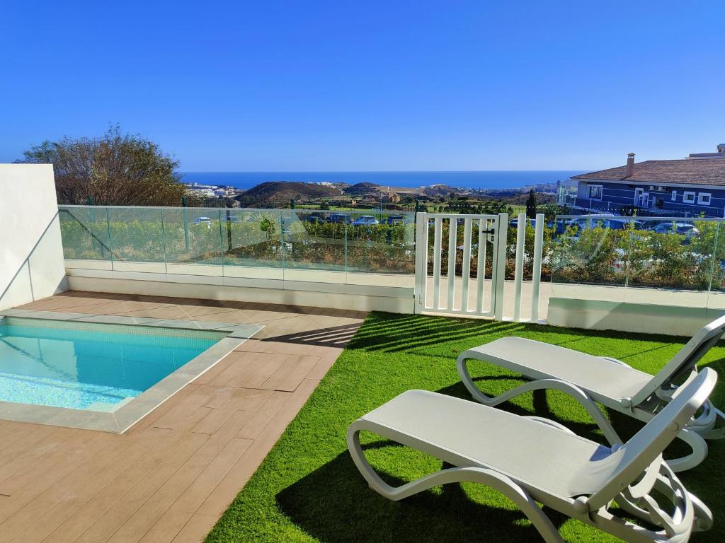 un patio con una silla y una piscina en Luxury Apartment in front Calanova Golf, en Mijas