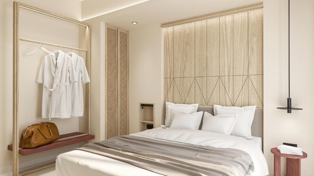 a bedroom with a large white bed and a closet at Falassarna Beach studios&apartments in Falasarna