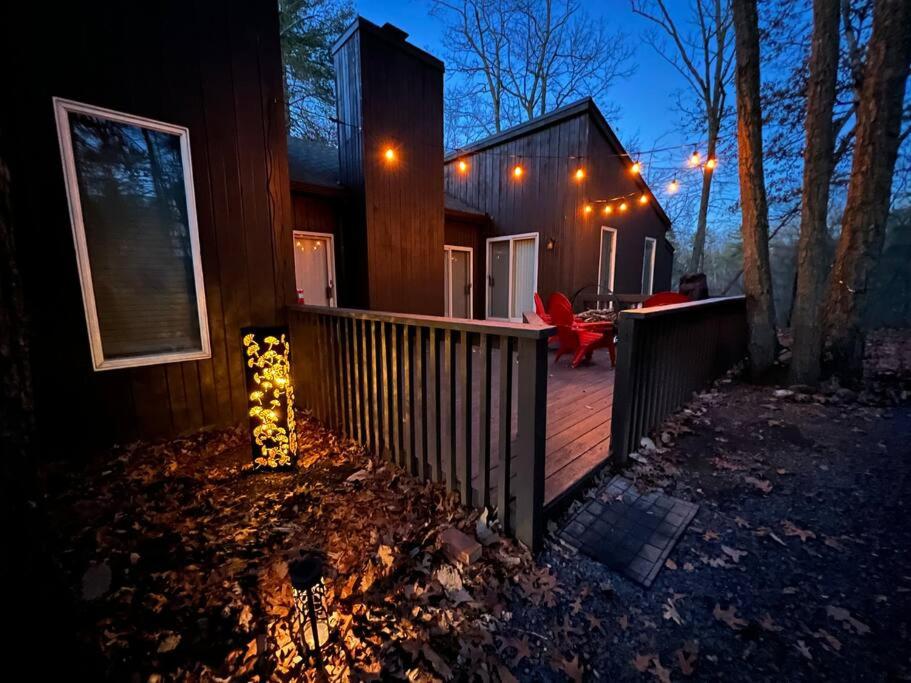 a house with a wooden deck at night at Black Bear Lodge in Basye