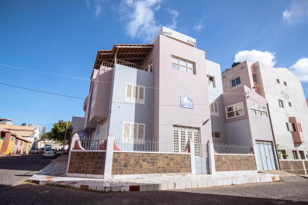 a large white building on the side of a street at Maya Apartments in Mindelo