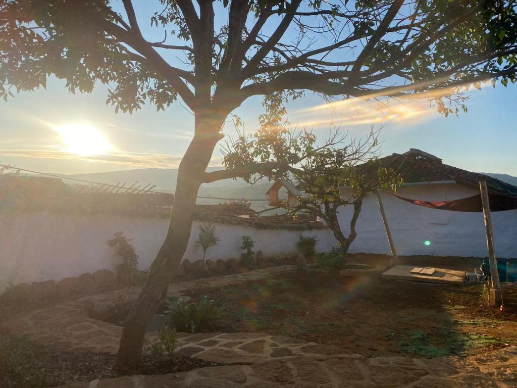 a misty sunrise in a house with a tree at El Principito Hospedaje in Barichara