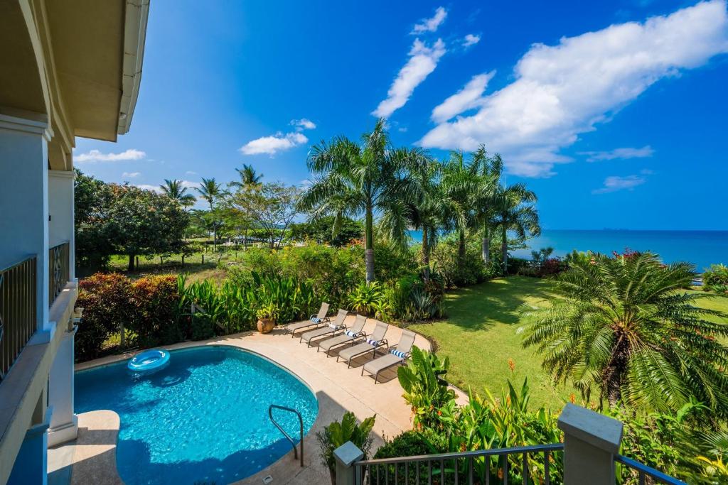 a view of a pool and the ocean from a house at Beachfront Potrero - nice 7-BR villa, private cook included - Casa Royal in Potrero