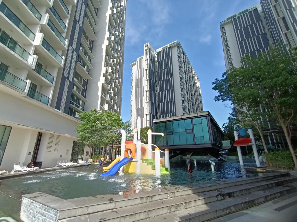 a water slide in a pool in a city at Pax 6+3 Grand Lux Melaka homestay in Melaka