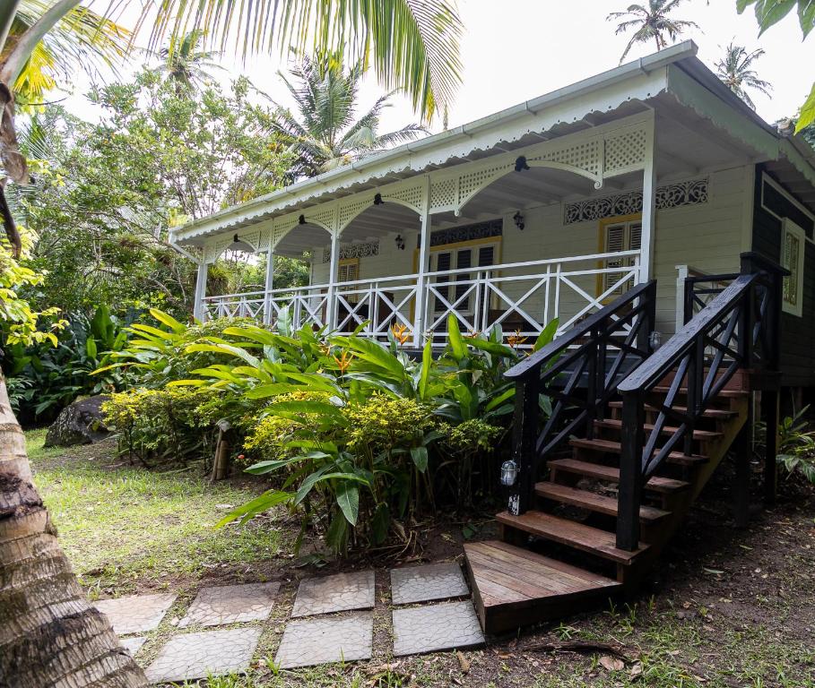 a house with a staircase in front of it at Fond Doux Eco Resort in Soufrière