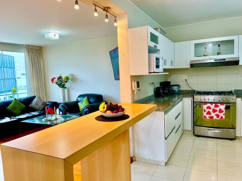a kitchen with a counter with a bowl of fruit on it at Smart Home Away Apartment in Lima