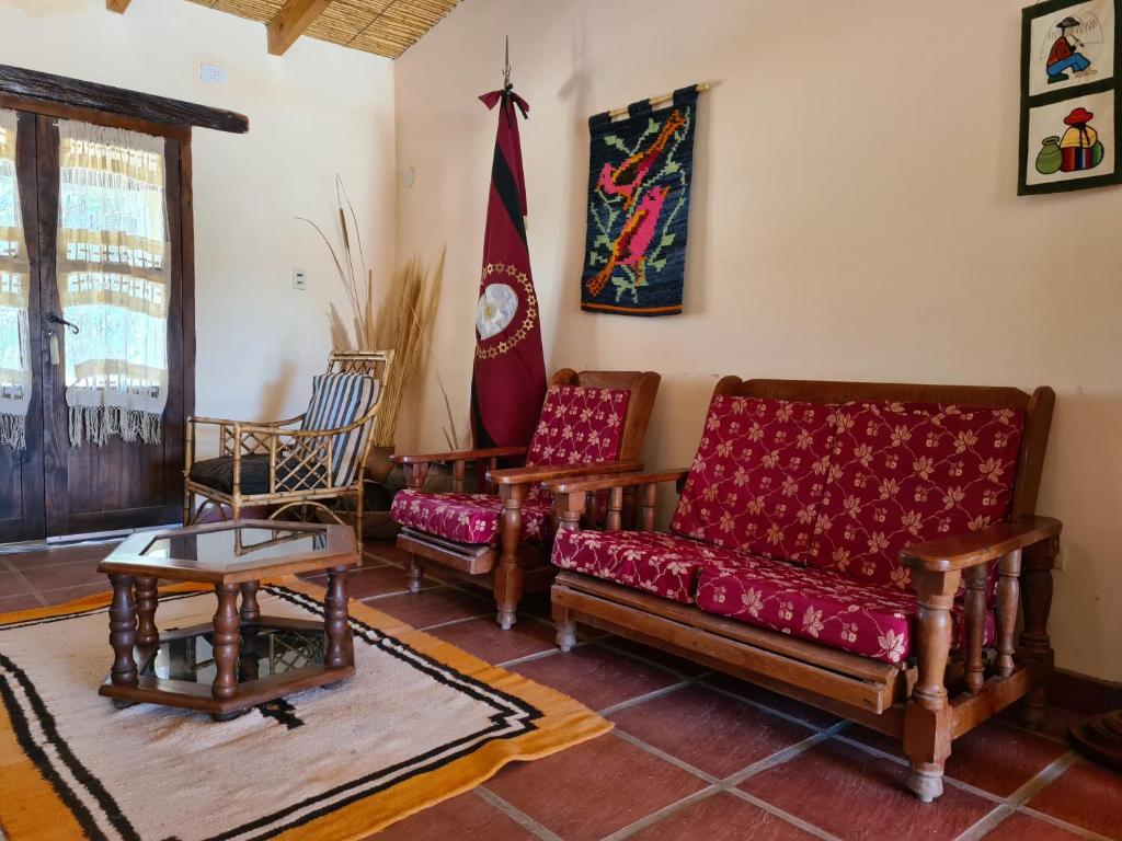 a living room with a couch and two chairs at Hostería La Enramada in Seclantás