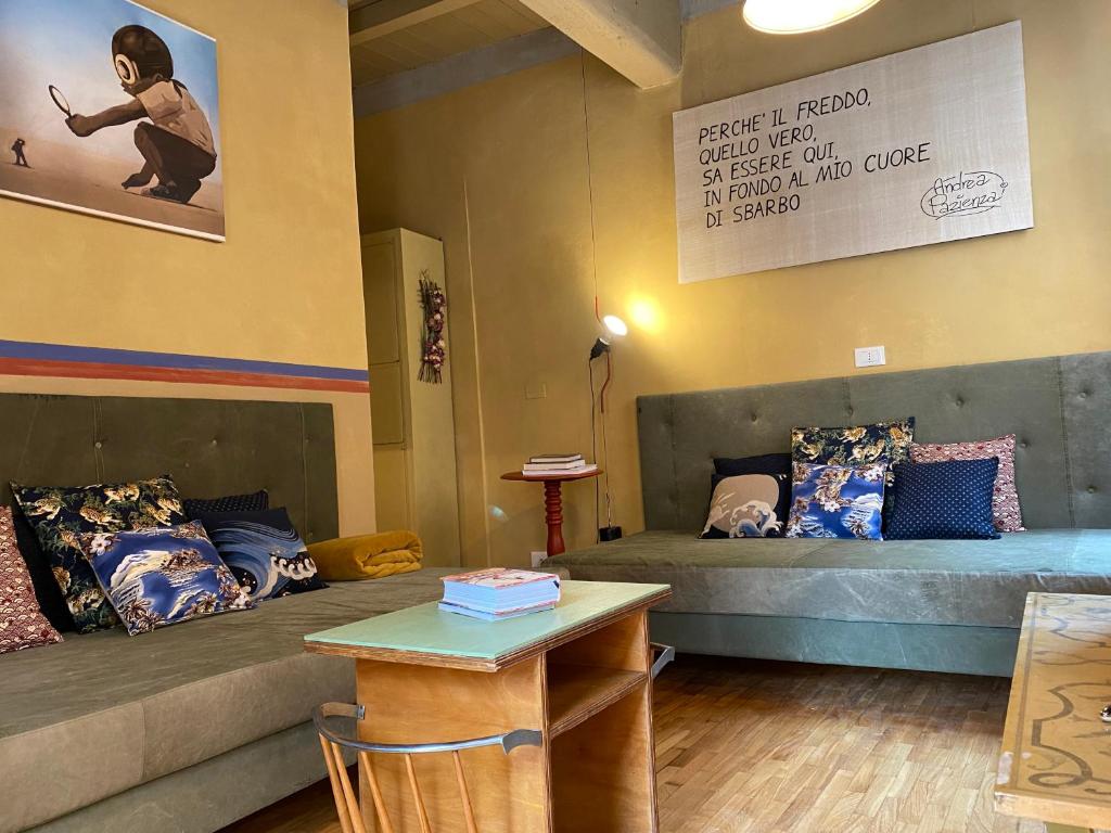 a living room with two beds and a table at Circusville in Bologna