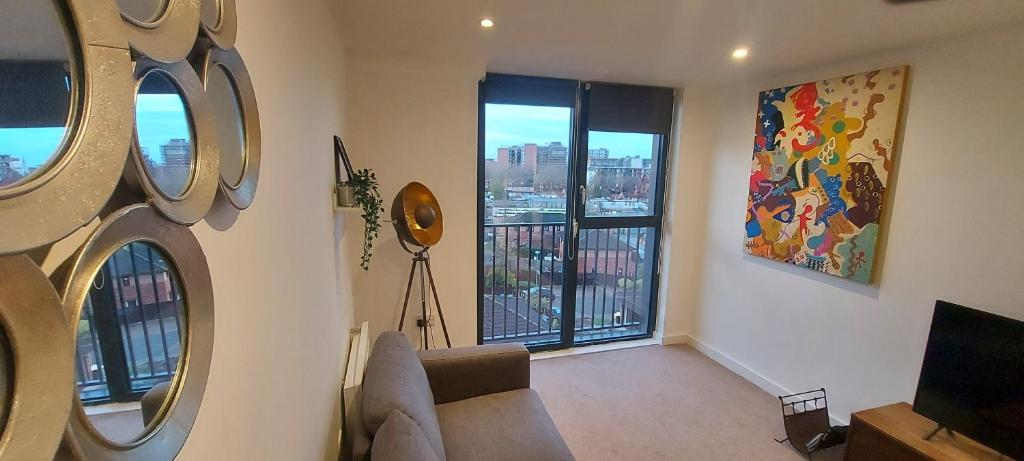 a living room with a couch and a large window at Chavasse Apartments L15DX in Liverpool