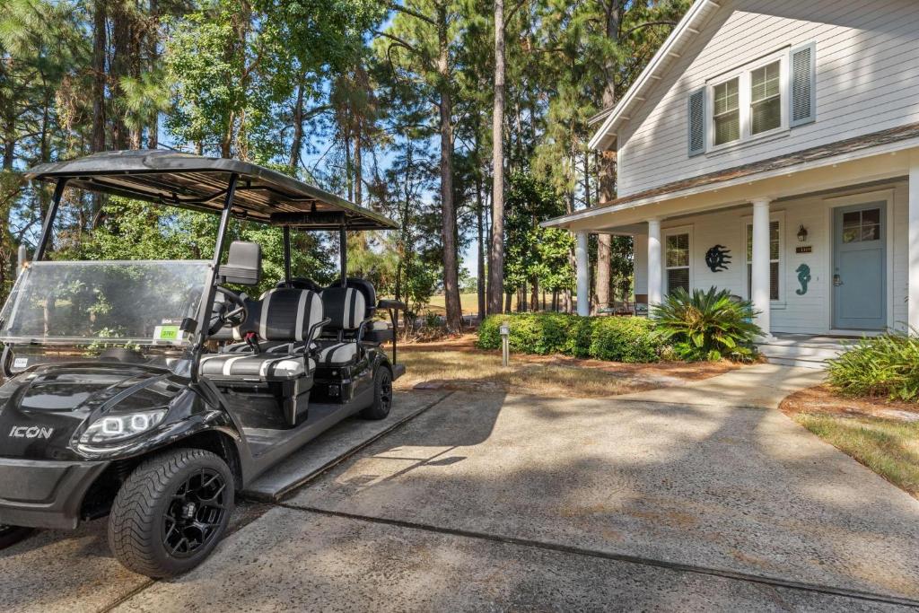 a golf cart parked in front of a house at 1369 Laurel Grove "The Crows Nest" in Destin