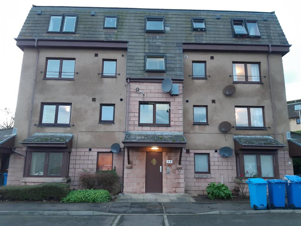 a large brick building with a door at Carvetii - Iona House, 2nd floor apartment sleeps up to 6 in Kirkcaldy
