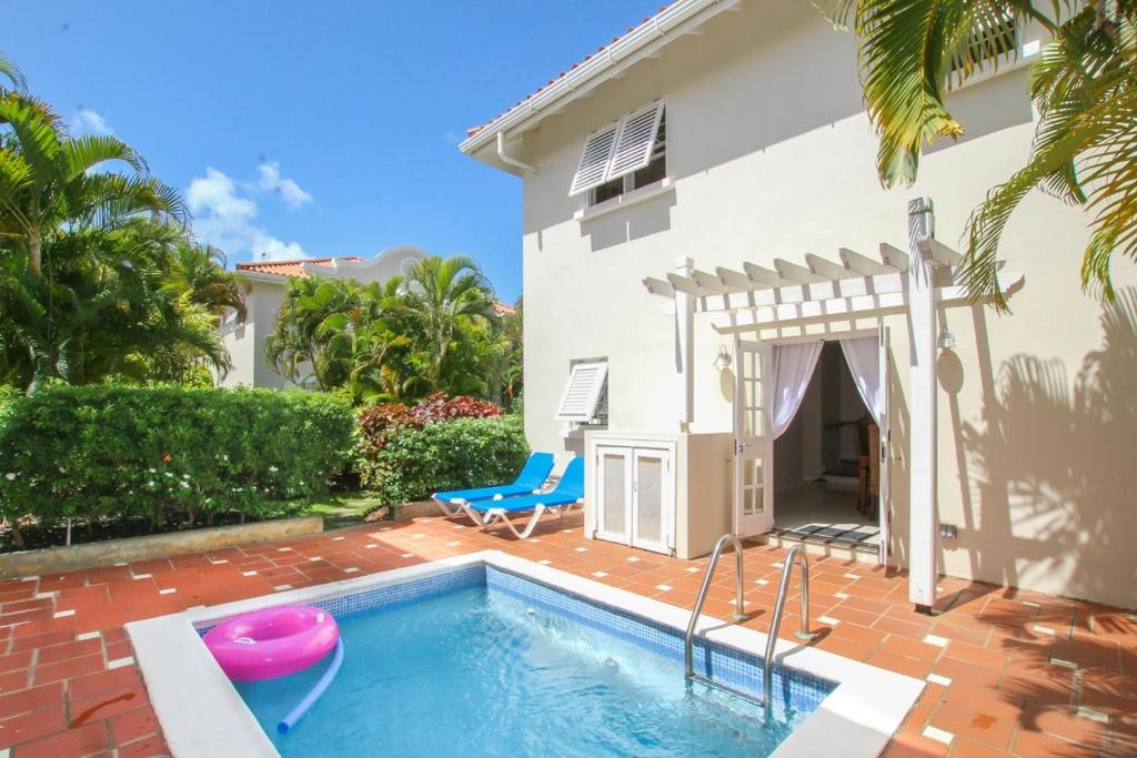 a villa with a swimming pool and a house at Turtle View 2 by BSL Rentals in Saint James