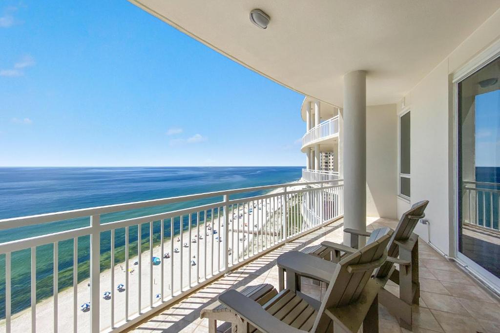 a balcony with two chairs and a view of the ocean at La Playa 1202 in Perdido Key