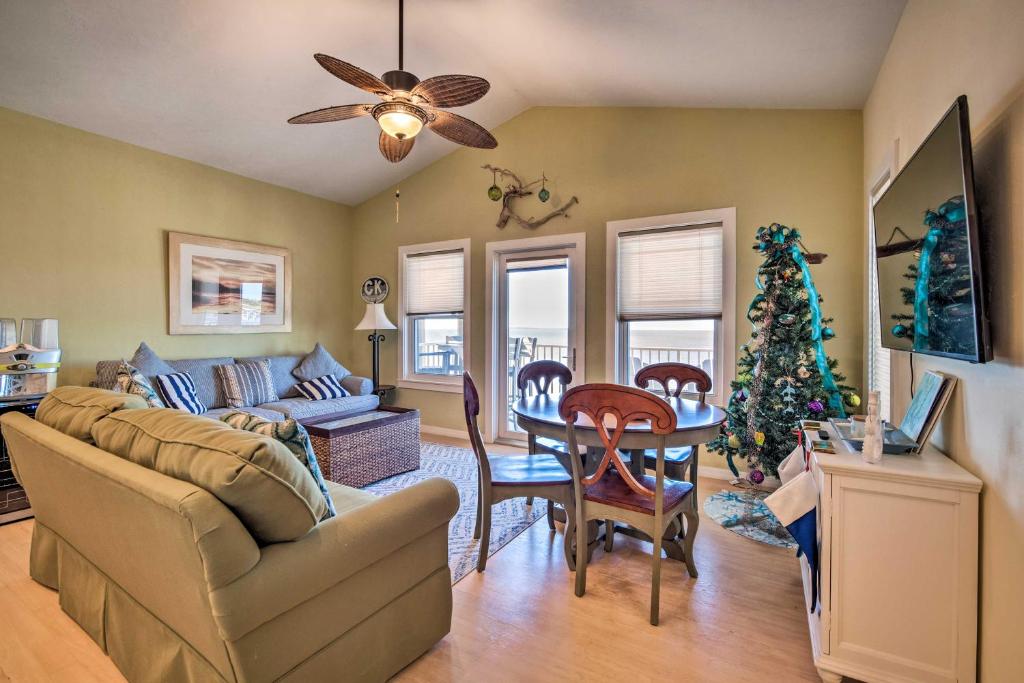 a living room with a christmas tree and a couch at Oceanfront Oasis in Cedar Key with 2 Balconies! in Cedar Key