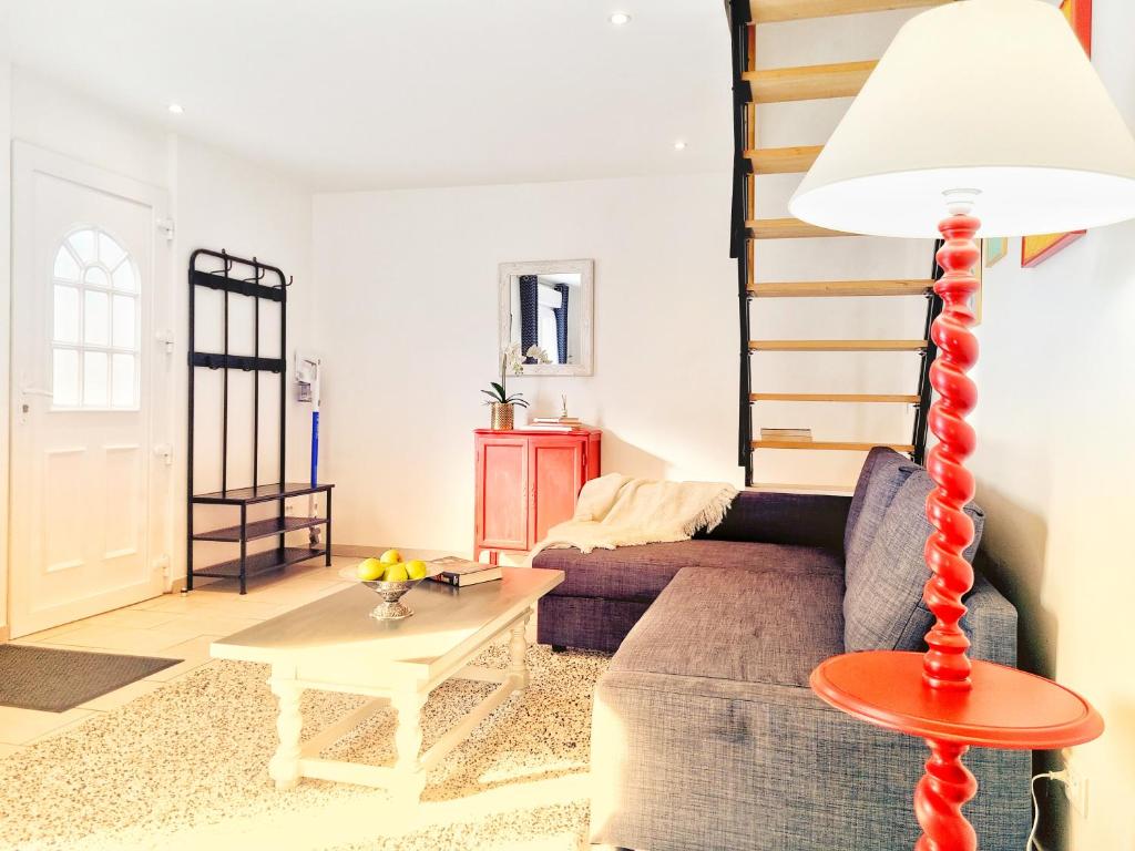 a living room with a couch and a table at Stableyard cottages in Lamorlaye