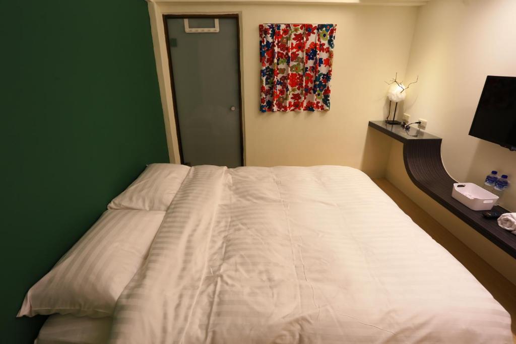 Postel nebo postele na pokoji v ubytování Mu Ju B&B