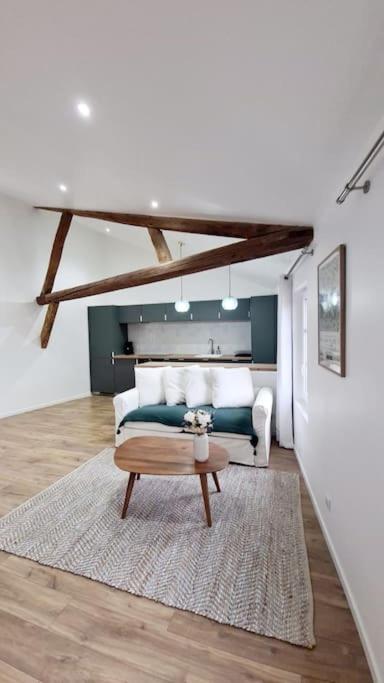 a living room with a bed and a coffee table at Victoire émeraude 301 hôtel de ville in Saint-Dizier