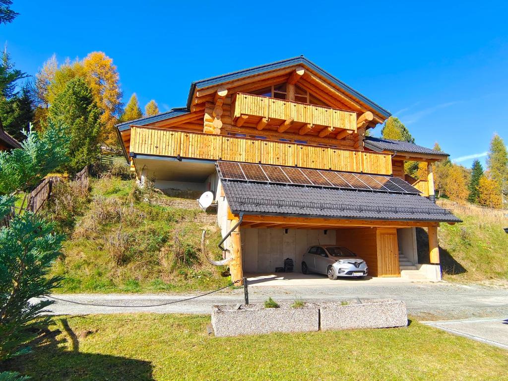 una casa con un coche aparcado delante de ella en Falkenblick en Hochrindl