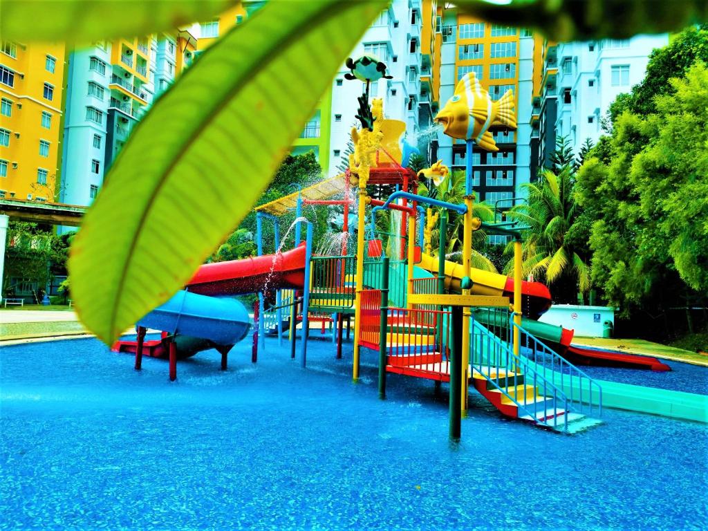 a playground with a water slide in a city at FREE 4 WATER THEMEPARK Tickets & WiFi Stay Melaka in Melaka