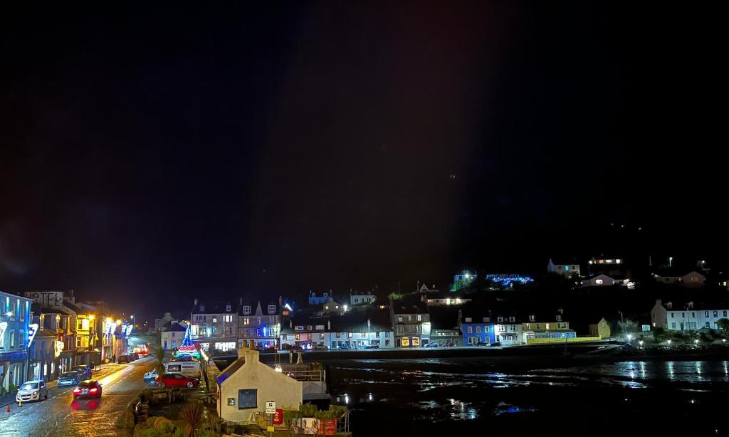a view of a city at night with lights at The waterfront in Tarbert