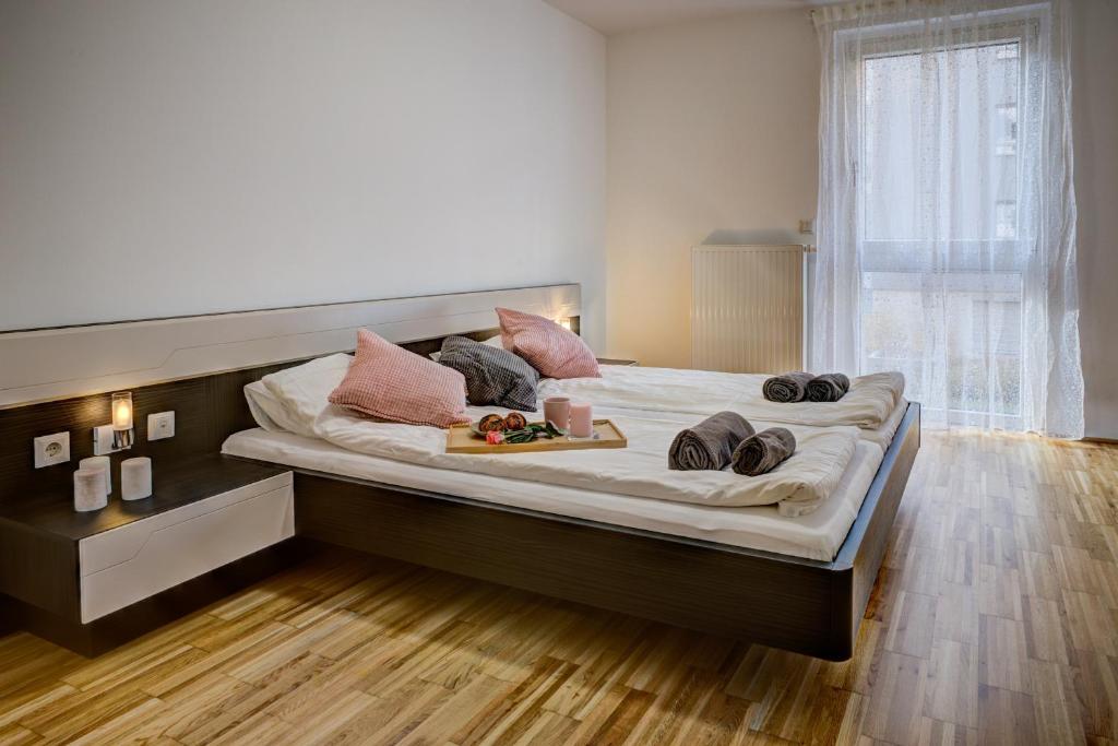 a large bed with two trays of food on it at Carin Deluxe II in Vienna