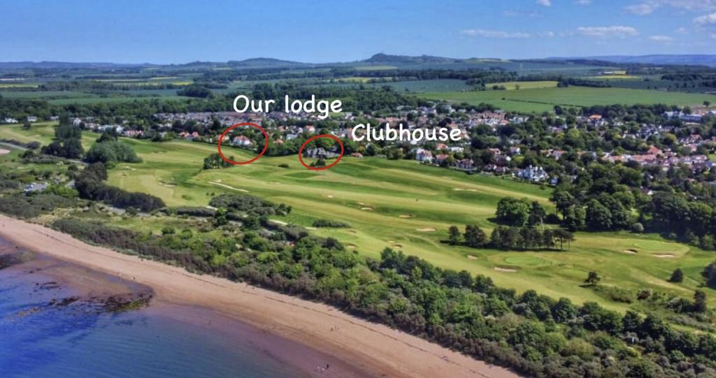 an overhead view of a golf course with a bicycle on it at STUNNING LODGE MINUTES FROM THE SEA AND GOLF COURSE in Longniddry