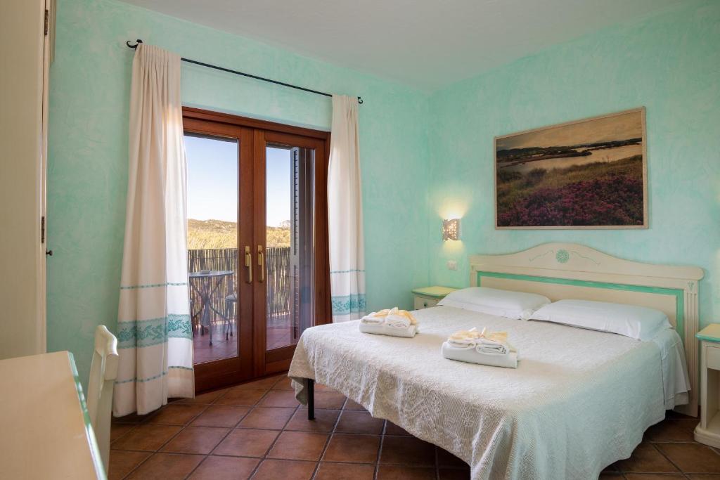 a bedroom with a bed with two towels on it at Affittacamere S'Alzola in Porto Rotondo