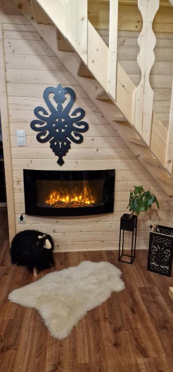 a living room with a fireplace with a snowflake on the wall at Trzy Szczyty-Turbacz in Grywałd