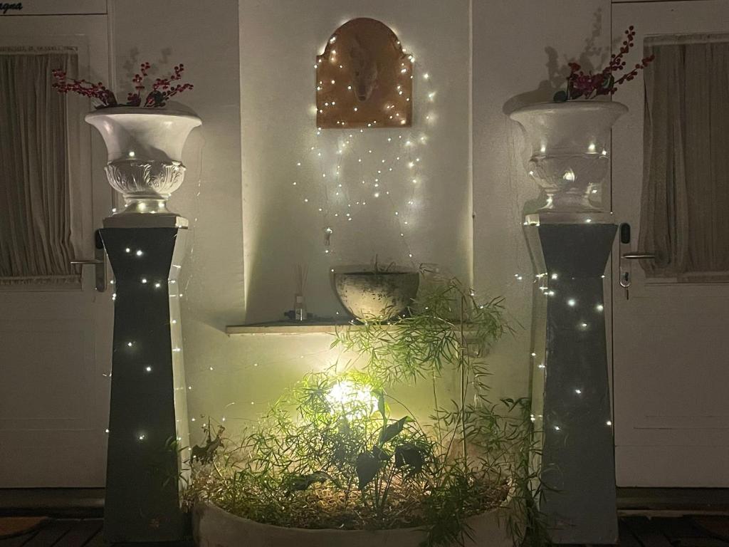 a couple of vases with lights in a room at Piazza Di Spagna Prestige in Rome