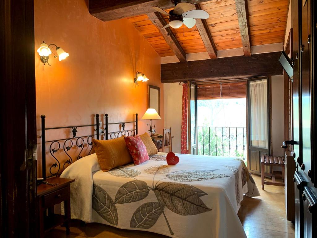 a bedroom with a bed in a room with a window at Hotel Doña Sancha in Covarrubias