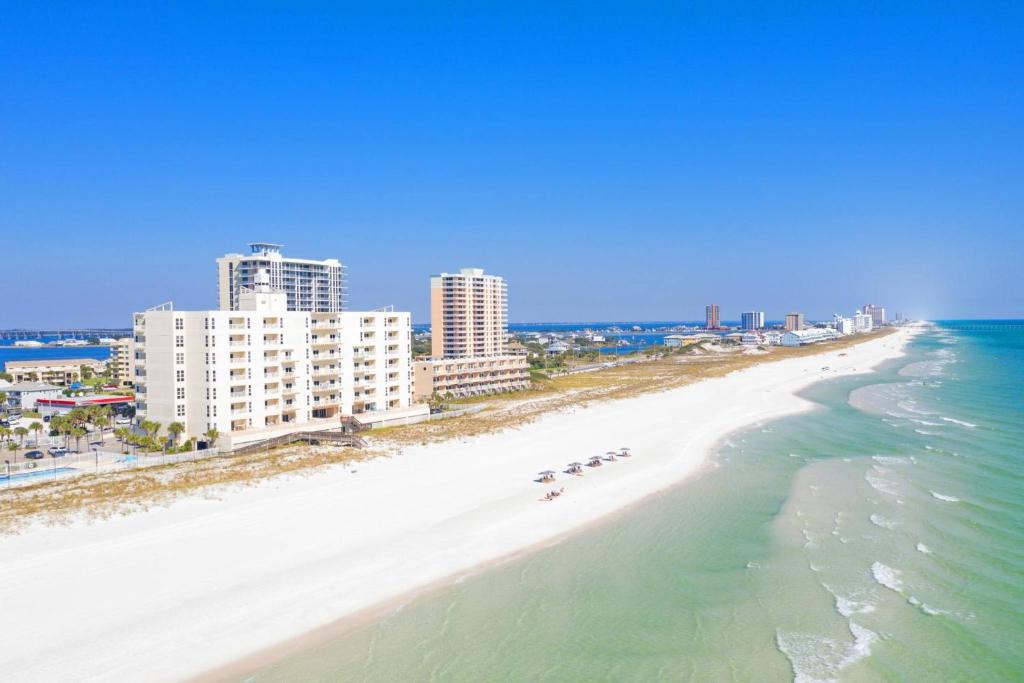 an aerial view of a beach with buildings and the ocean at Pensacola Beach Front Emerald Waters in Pensacola Beach