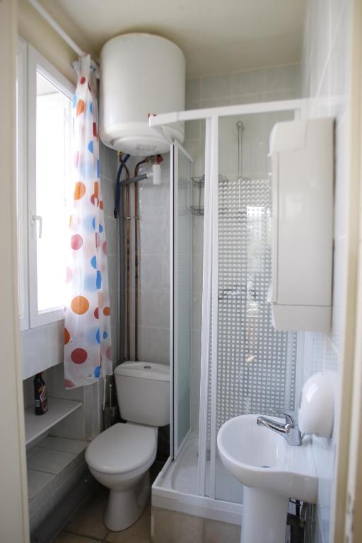 a bathroom with a toilet and a shower and a sink at RENT APPART - Colombes in Colombes