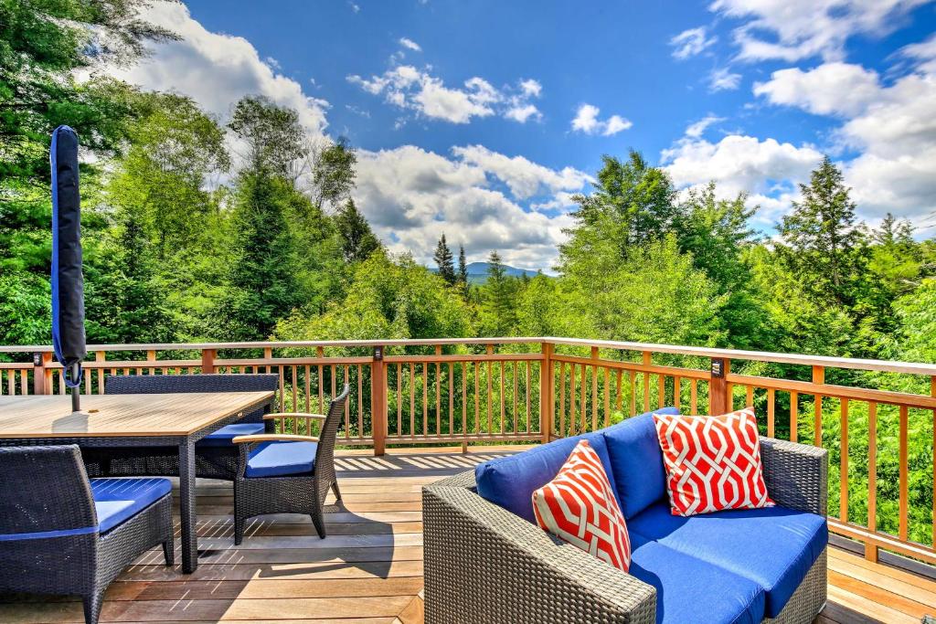 a deck with a wooden table and chairs and a table and chairs at Pet-Friendly House with Deck - 10 Mi to Stowe Mtn! in Stowe