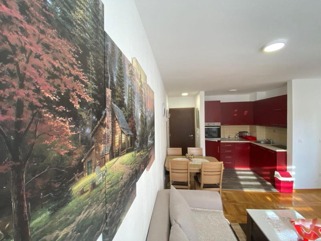 a living room with a couch and a painting on the wall at Apartmani Kršić in Zlatibor
