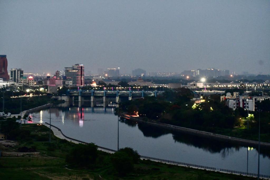 a view of a river with a city at night at Kamil’s Studio Apartment in Lucknow