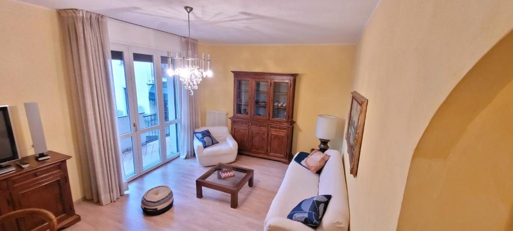 a living room with a couch and a tv at Spacious apartment at Como lake in Mandello del Lario