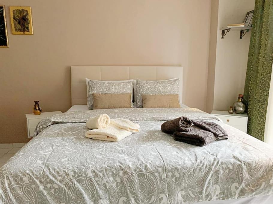 a bedroom with a bed with towels on it at Cozy studio, 1min from Kamara in Thessaloniki