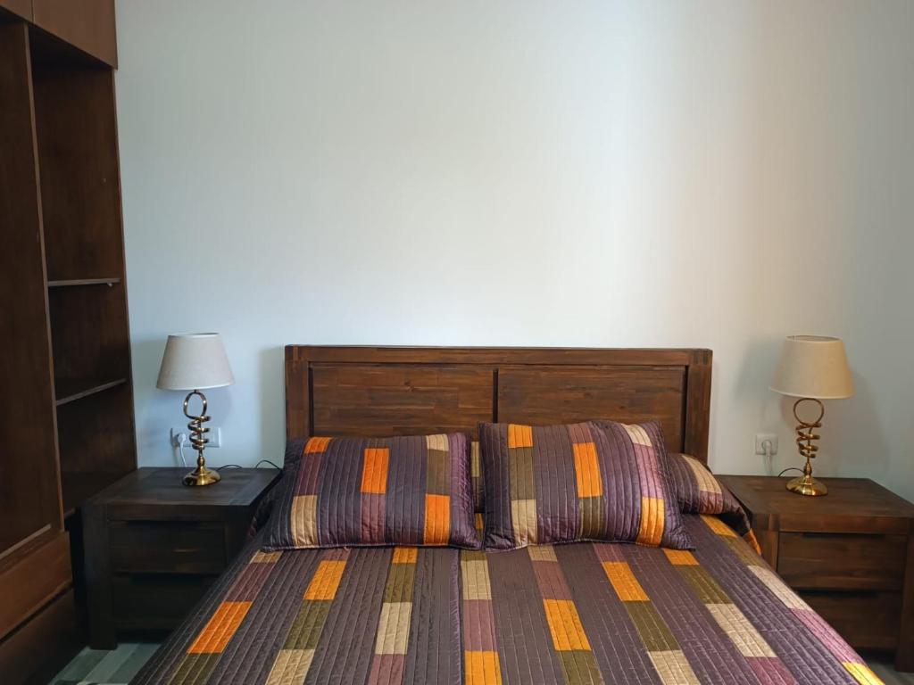 a bedroom with a bed and two night stands with lamps at The Oxygen 7 in Tetouan