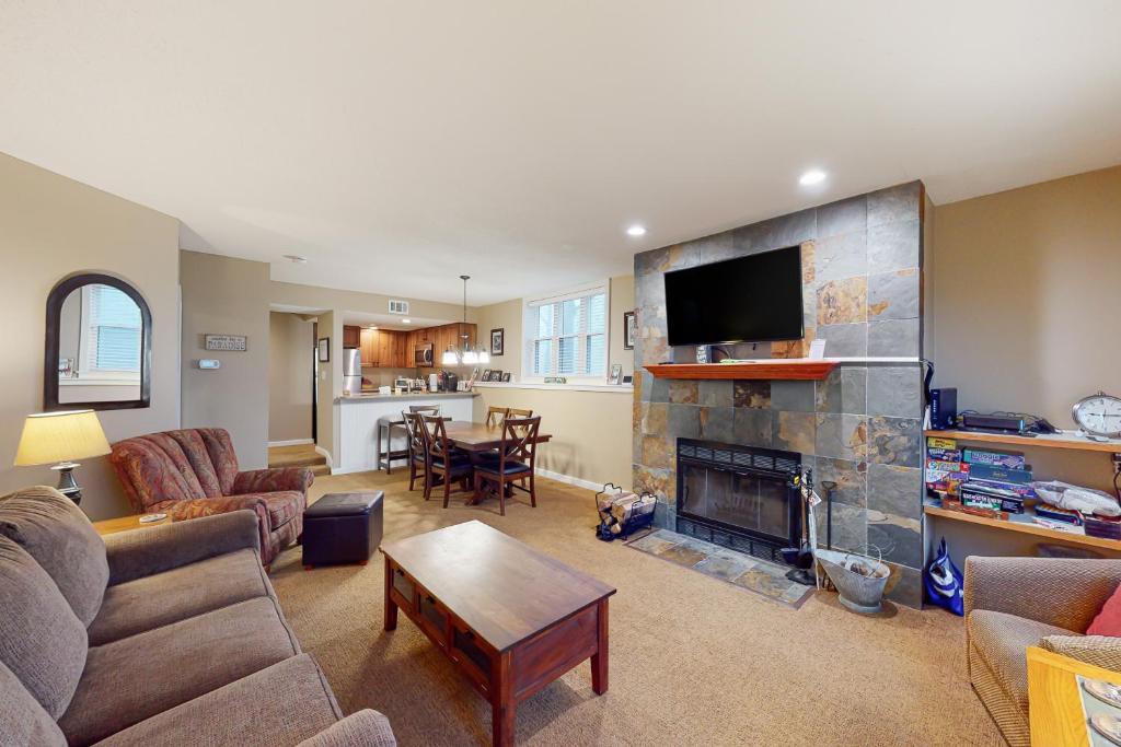 a living room with a couch and a fireplace at Winterplace G101 in Ludlow