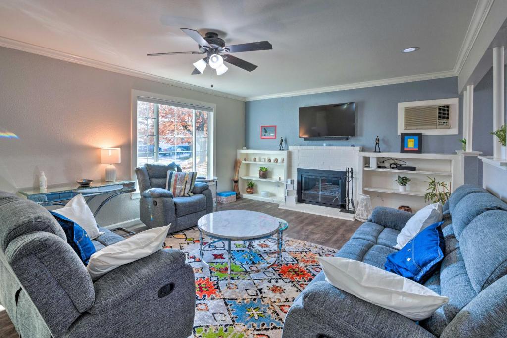 a living room with two blue couches and a tv at Vibrant Sacramento Home with Yard and Patio! in Freeport